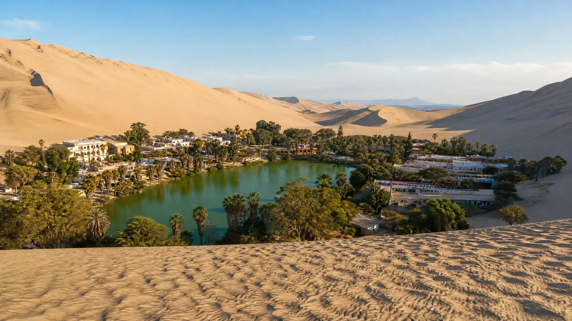 A natural desert oasis surrounded by towering sand dunes. Ride tubular buggies, sandboard down the slopes, and watch the desert sunset.
